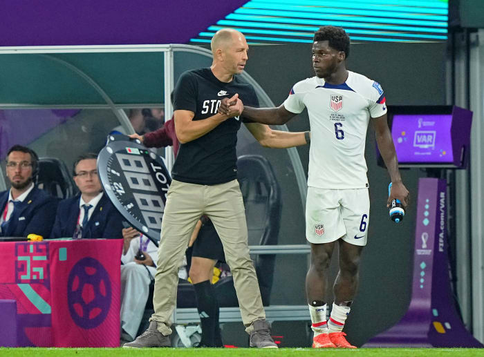 USA manager Gregg Berhalter talks with midfielder Yunus Musah.